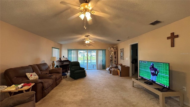 living room with lofted ceiling, light colored carpet, ceiling fan, and a textured ceiling