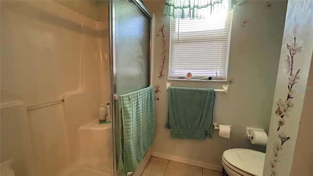 full bathroom featuring baseboards, a stall shower, toilet, and tile patterned flooring