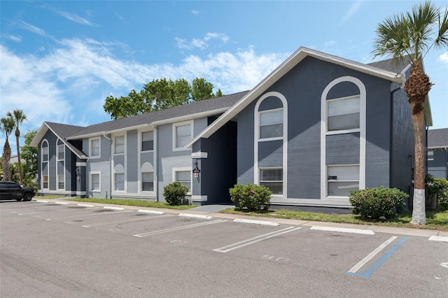 view of building exterior with uncovered parking