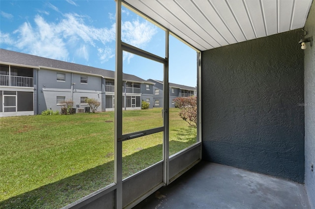 unfurnished sunroom with a wealth of natural light and a residential view