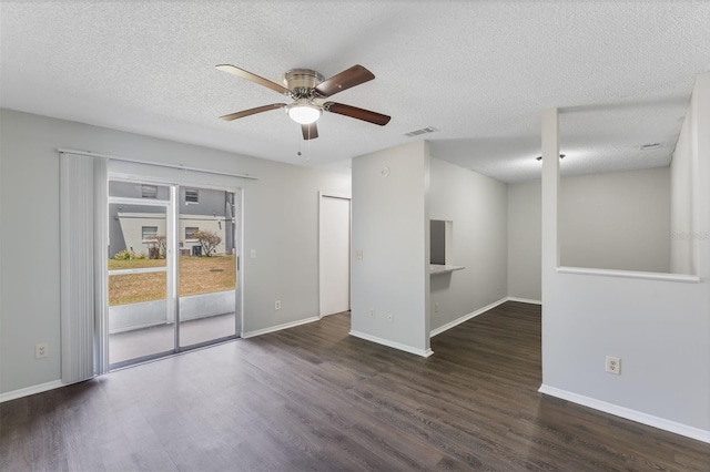 unfurnished room with a textured ceiling, ceiling fan, visible vents, and wood finished floors