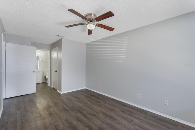 empty room with visible vents, a ceiling fan, baseboards, and dark wood-type flooring