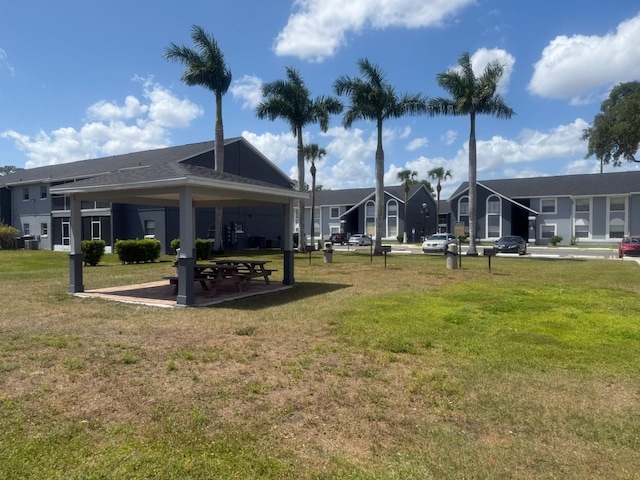 view of property's community with a lawn, a gazebo, and a residential view