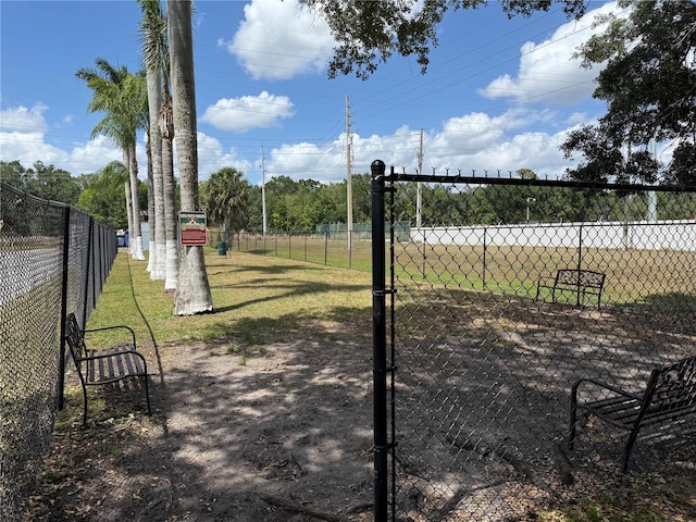 view of property's community featuring fence and a lawn