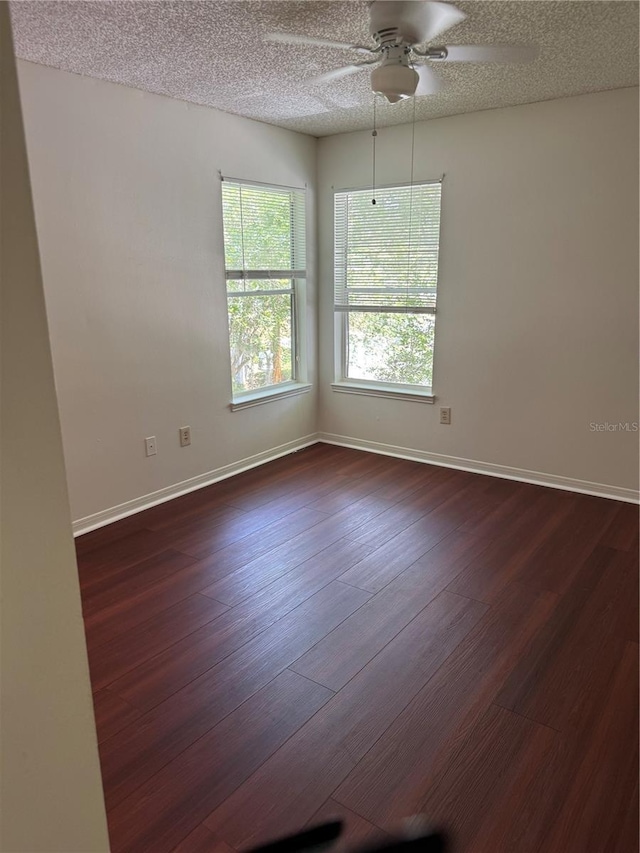 2516 Grassy Point Dr Unit 210, Lake Mary, FL 32746 - spare room featuring a ceiling fan, dark wood-style flooring, a textured ceiling, and baseboards