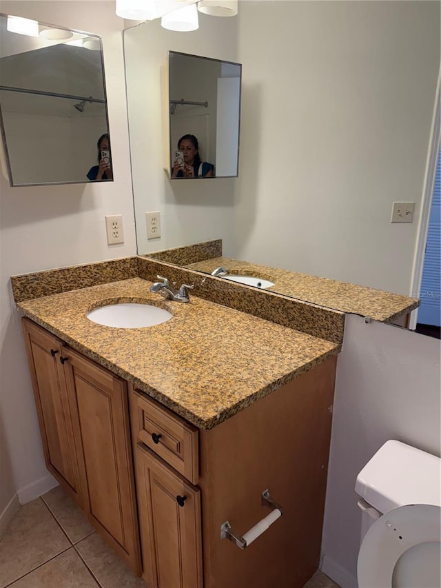 2516 Grassy Point Dr Unit 210, Lake Mary, FL 32746 - bathroom featuring vanity, tile patterned floors, and toilet