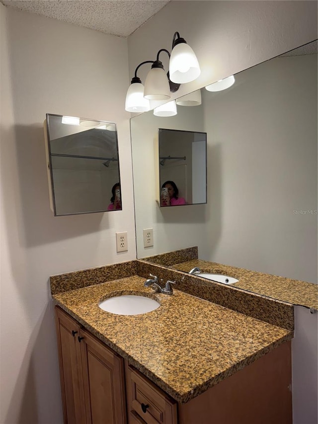 2516 Grassy Point Dr Unit 210, Lake Mary, FL 32746 - bathroom featuring a textured ceiling and vanity