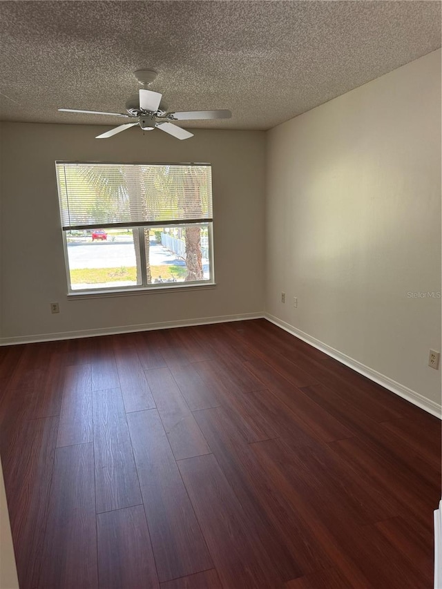 2516 Grassy Point Dr Unit 210, Lake Mary, FL 32746 - empty room featuring dark wood finished floors, plenty of natural light, a ceiling fan, a textured ceiling, and baseboards