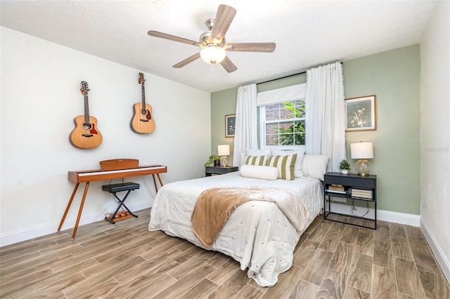 4332 Lake Underhill Rd Unit 12D10, Orlando, FL 32803 - bedroom featuring baseboards, ceiling fan, and wood finished floors