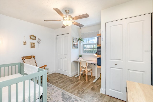 4332 Lake Underhill Rd Unit 12D10, Orlando, FL 32803 - bedroom featuring multiple closets, baseboards, ceiling fan, a nursery area, and light wood finished floors