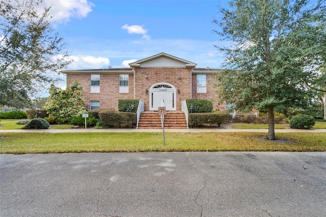 4332 Lake Underhill Rd Unit 12D10, Orlando, FL 32803 - view of front facade featuring a front lawn and brick siding