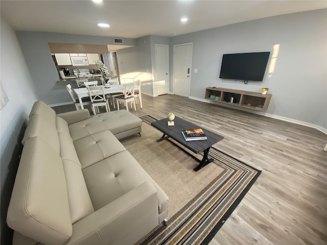 3147 Britannia Blvd Unit A, Kissimmee, FL 34747 - living area featuring baseboards, recessed lighting, wood finished floors, and visible vents