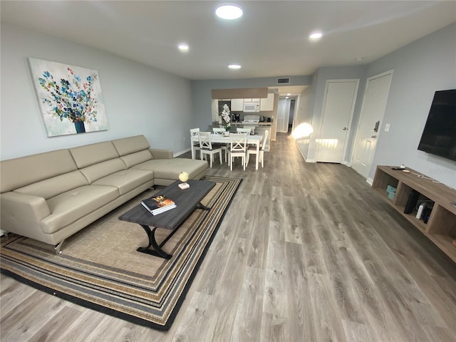 3147 Britannia Blvd Unit A, Kissimmee, FL 34747 - living area with baseboards, recessed lighting, wood finished floors, and visible vents