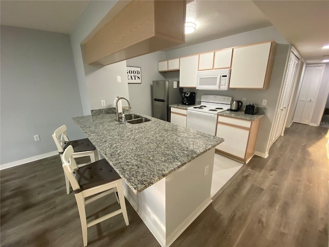 3147 Britannia Blvd Unit A, Kissimmee, FL 34747 - kitchen with white appliances, a sink, and wood finished floors