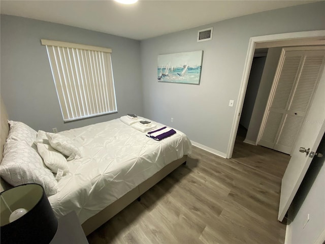 3147 Britannia Blvd Unit A, Kissimmee, FL 34747 - bedroom featuring baseboards, visible vents, wood finished floors, and a closet