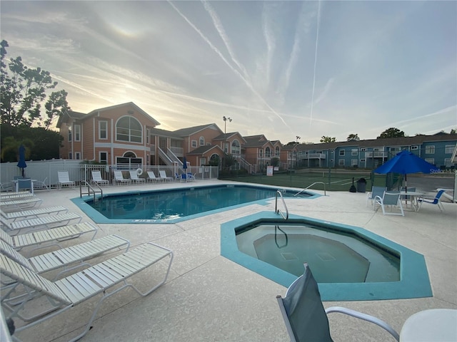 3147 Britannia Blvd Unit A, Kissimmee, FL 34747 - community pool with fence, a community hot tub, a patio area, and a residential view
