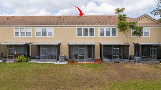 3567 Shallot Dr Unit 103, Orlando, FL 32835 - back of house with a sunroom, central AC, and a yard