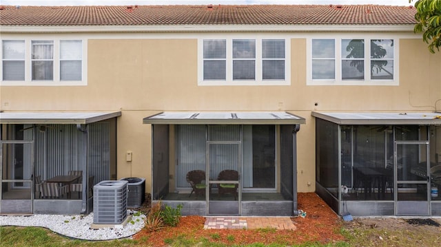 3567 Shallot Dr Unit 103, Orlando, FL 32835 - rear view of house with a sunroom, cooling unit, and stucco siding