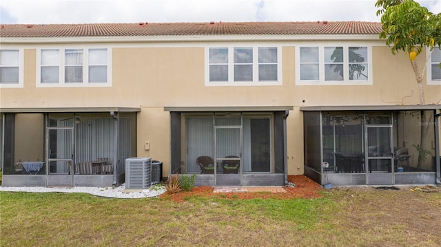 3567 Shallot Dr Unit 103, Orlando, FL 32835 - back of house featuring a sunroom, central AC, and a yard