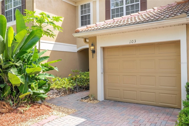 3567 Shallot Dr Unit 103, Orlando, FL 32835 - entrance to property with decorative driveway, stucco siding, and a tile roof