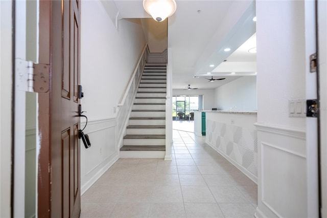 3567 Shallot Dr Unit 103, Orlando, FL 32835 - entrance foyer with stairs, a decorative wall, light tile patterned floors, recessed lighting, and wainscoting