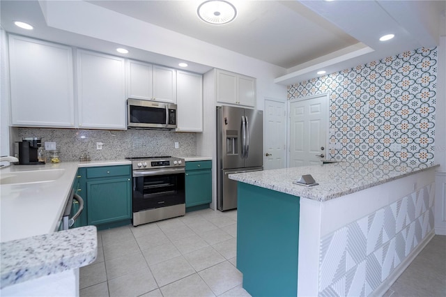 3567 Shallot Dr Unit 103, Orlando, FL 32835 - kitchen featuring stainless steel appliances, tasteful backsplash, a sink, and recessed lighting