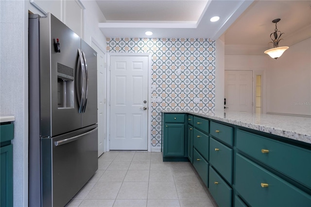 3567 Shallot Dr Unit 103, Orlando, FL 32835 - kitchen with stainless steel fridge with ice dispenser, green cabinets, light tile patterned flooring, light stone counters, and wallpapered walls