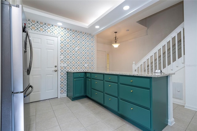 3567 Shallot Dr Unit 103, Orlando, FL 32835 - kitchen with freestanding refrigerator, green cabinetry, wallpapered walls, recessed lighting, and light tile patterned floors