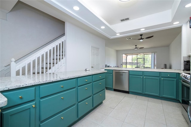 3567 Shallot Dr Unit 103, Orlando, FL 32835 - kitchen featuring appliances with stainless steel finishes, recessed lighting, light tile patterned floors, ceiling fan, and a tray ceiling