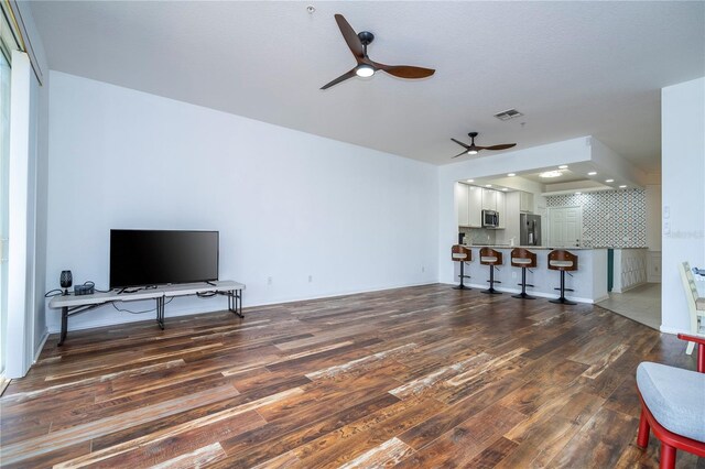 3567 Shallot Dr Unit 103, Orlando, FL 32835 - unfurnished living room featuring ceiling fan and wood finished floors