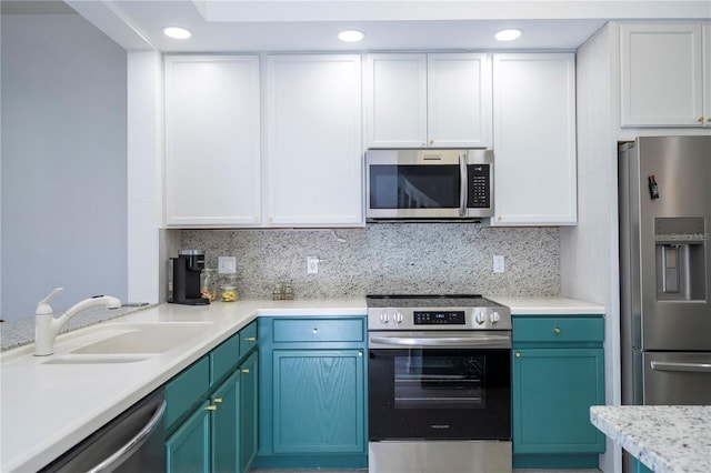 3567 Shallot Dr Unit 103, Orlando, FL 32835 - kitchen with appliances with stainless steel finishes, a sink, white cabinets, light countertops, and recessed lighting