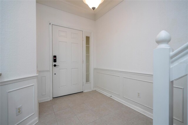 3567 Shallot Dr Unit 103, Orlando, FL 32835 - foyer entrance featuring a decorative wall, light tile patterned flooring, a wainscoted wall, and ornamental molding