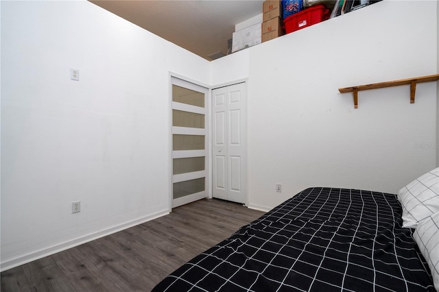 3567 Shallot Dr Unit 103, Orlando, FL 32835 - unfurnished bedroom featuring wood finished floors, baseboards, and a closet