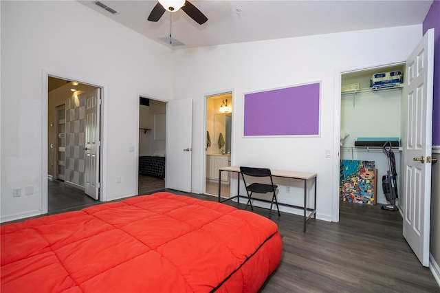 3567 Shallot Dr Unit 103, Orlando, FL 32835 - bedroom with a spacious closet, connected bathroom, a closet, wood finished floors, and baseboards