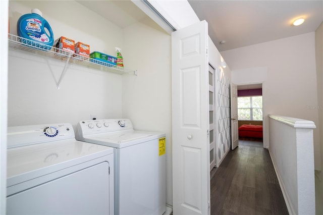 3567 Shallot Dr Unit 103, Orlando, FL 32835 - clothes washing area featuring washing machine and dryer, dark wood-type flooring, and baseboards