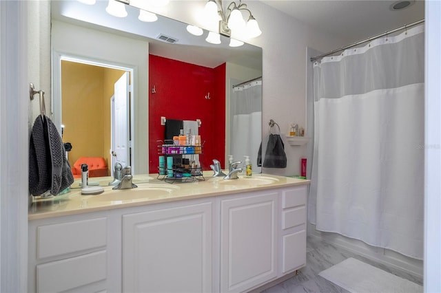 3567 Shallot Dr Unit 103, Orlando, FL 32835 - full bathroom with double vanity, marble finish flooring, and a chandelier