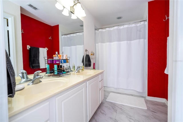 3567 Shallot Dr Unit 103, Orlando, FL 32835 - bathroom with double vanity and marble look tile flooring