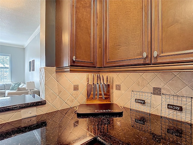 7509 Mourning Dove Cir Unit 203, Reunion, FL 34747 - details with a textured ceiling, ornamental molding, and tasteful backsplash