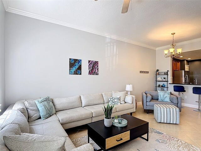 7509 Mourning Dove Cir Unit 203, Reunion, FL 34747 - living room with crown molding, light tile patterned floors, baseboards, and ceiling fan with notable chandelier