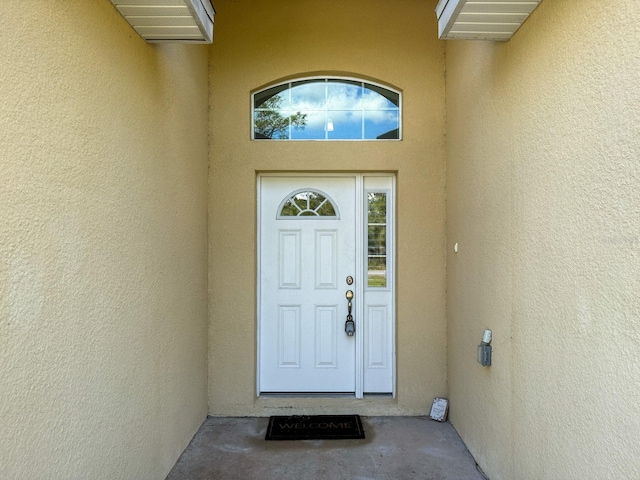 entrance to property with stucco siding