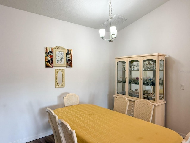 dining area featuring an inviting chandelier and wood finished floors