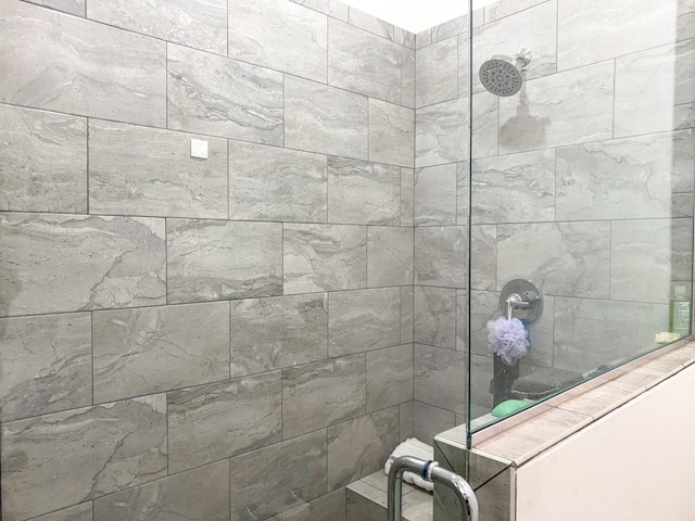 bathroom with a tile shower