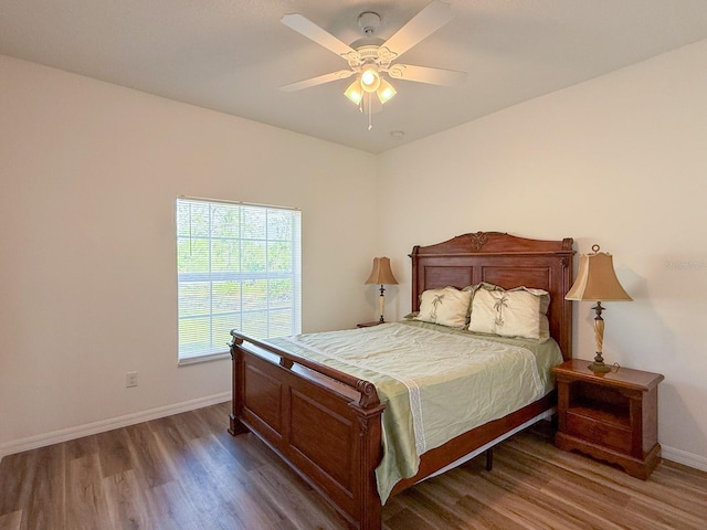 bedroom featuring baseboards, ceiling fan, and wood finished floors