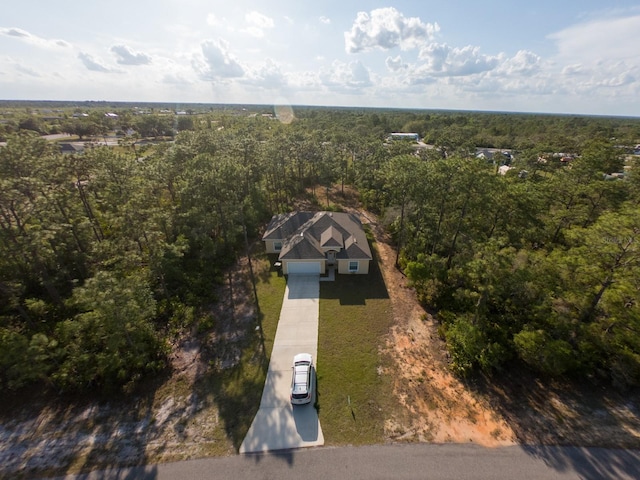 bird's eye view featuring a wooded view