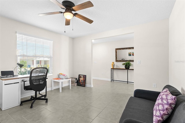 740 Simone Ct, Haines City, FL 33844 - home office featuring a textured ceiling, ceiling fan, baseboards, and light tile patterned flooring