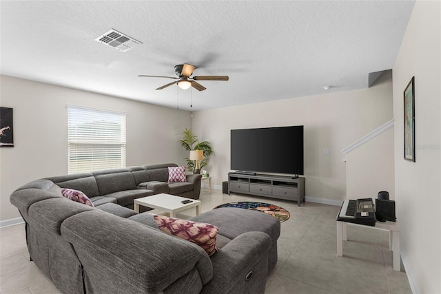 740 Simone Ct, Haines City, FL 33844 - living room with a textured ceiling, a ceiling fan, baseboards, light tile patterned floors, and visible vents