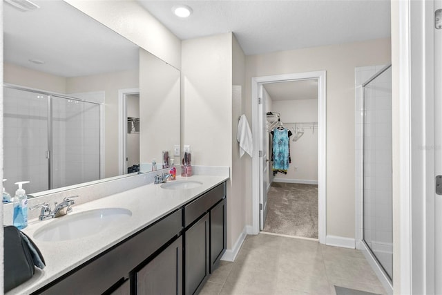 740 Simone Ct, Haines City, FL 33844 - bathroom with double vanity, a sink, a stall shower, and tile patterned floors
