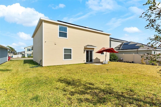 740 Simone Ct, Haines City, FL 33844 - back of property featuring a yard, fence, and a patio area