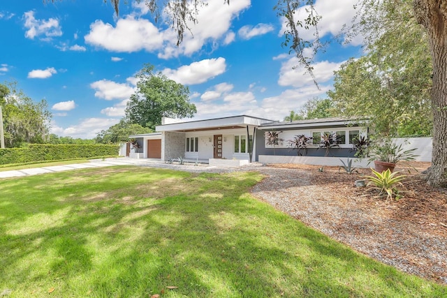 2525 Venetian Way, Winter Park, FL 32789 - rear view of property with a lawn and concrete driveway