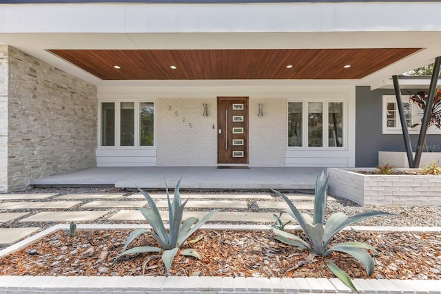 2525 Venetian Way, Winter Park, FL 32789 - view of exterior entry featuring a porch and brick siding